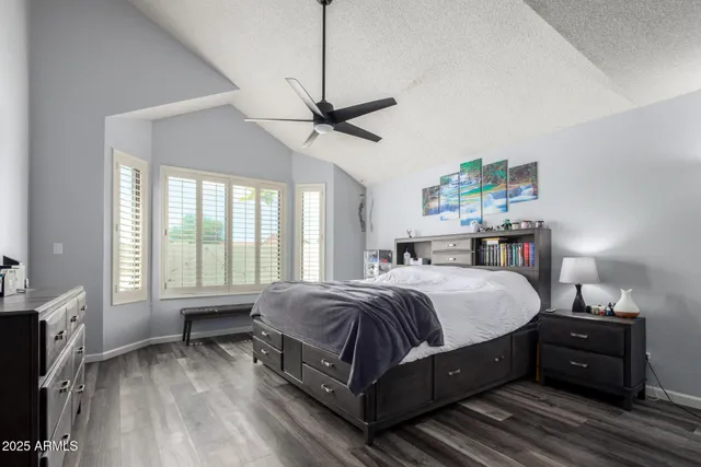 a bedroom with a bed chandelier and a window