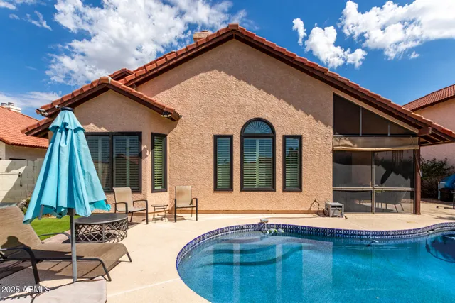 a view of house with swimming pool outdoor seating