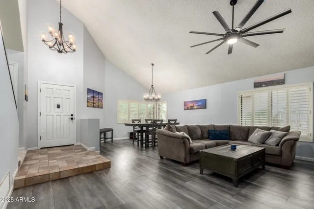 a living room with furniture and a chandelier