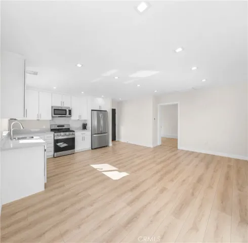a view of kitchen with wooden floor