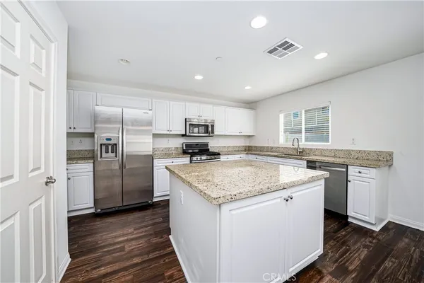a kitchen with a sink stove and refrigerator