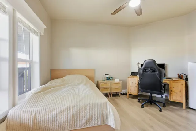 a bedroom with a bed and a chair