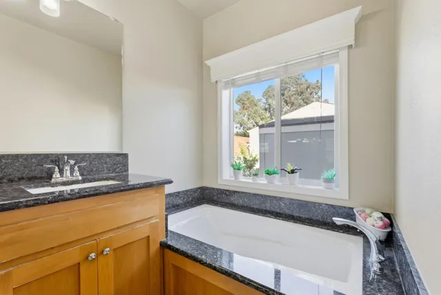 a bath tub sitting next to a window