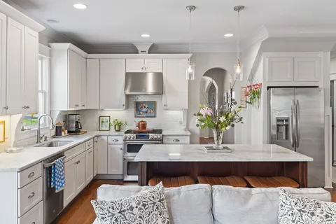 a kitchen with a refrigerator and a sink