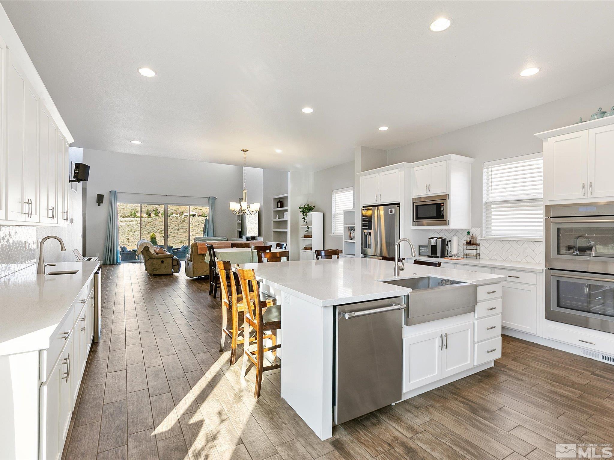 1564 Elk Run Trail Reno, NV 89523 - Photo 3 of 18 a large white kitchen with lots of counter space a sink appliances and cabinets