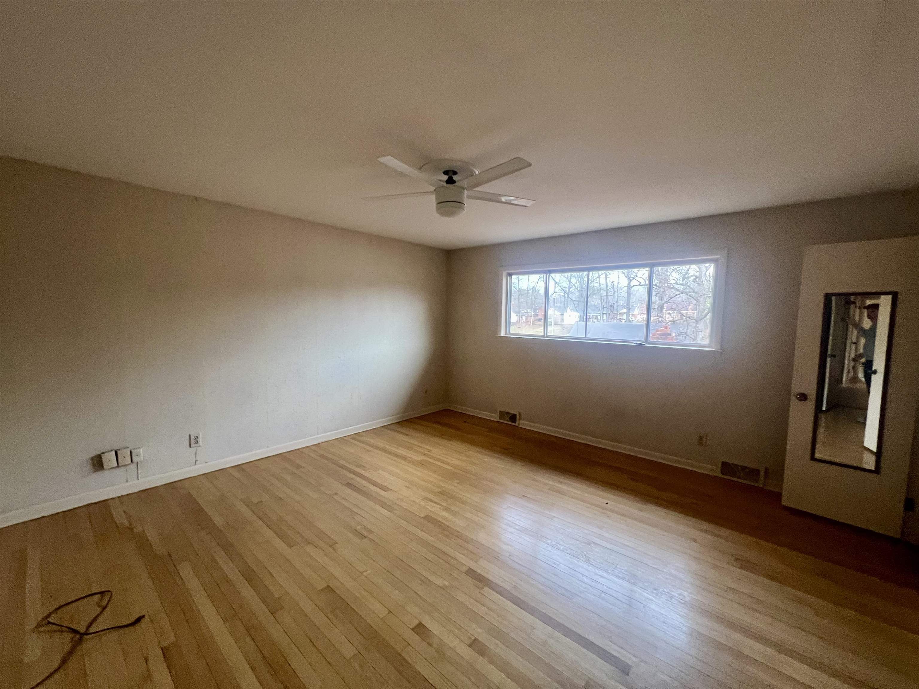 3153 Kirkcaldy Road Memphis, TN 38128 - Photo 12 of 28 Empty room with light wood-style flooring and a ceiling fan
