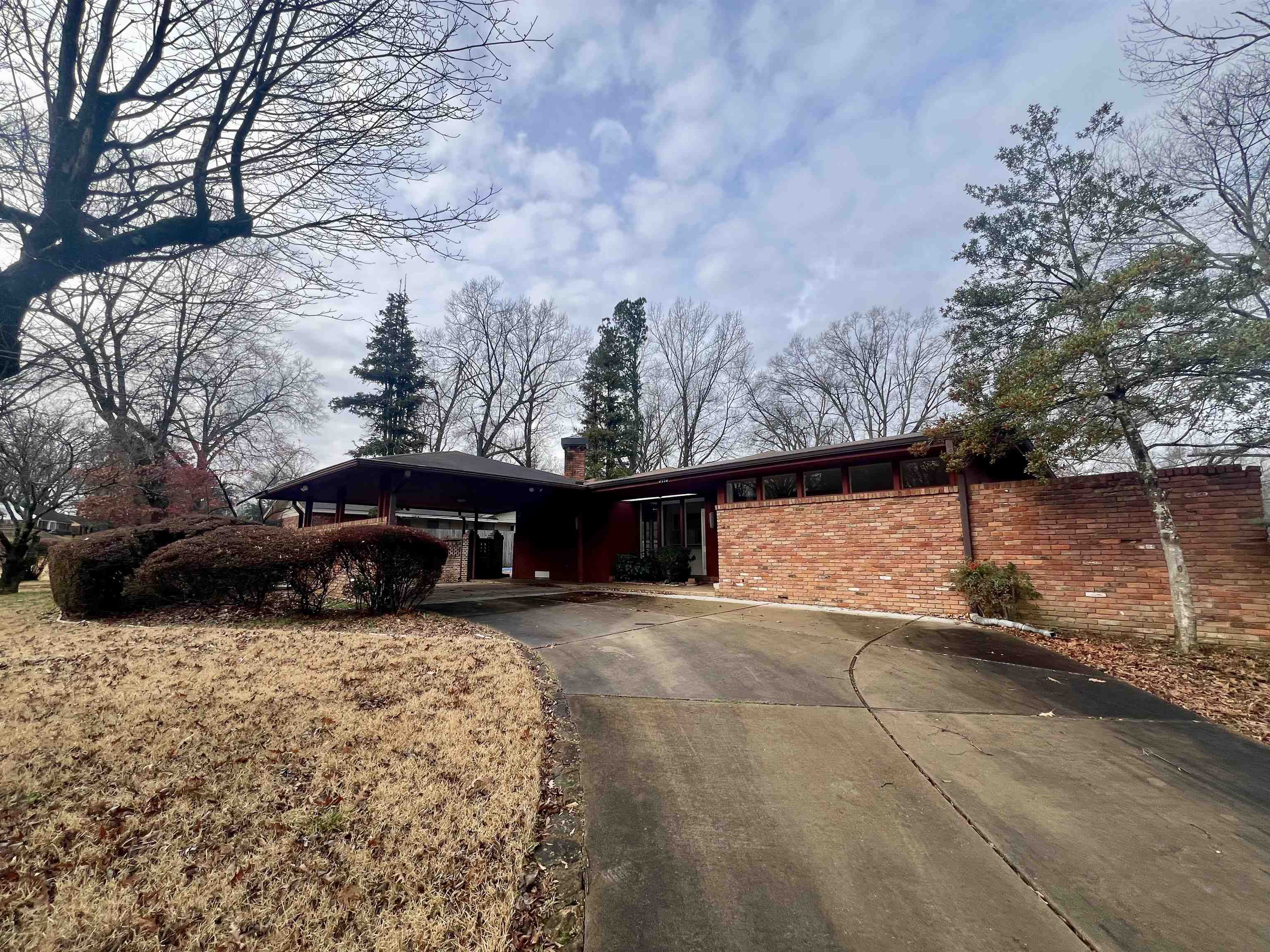 3153 Kirkcaldy Road Memphis, TN 38128 - Photo 17 of 28 View of front facade with driveway, brick siding, and a chimney