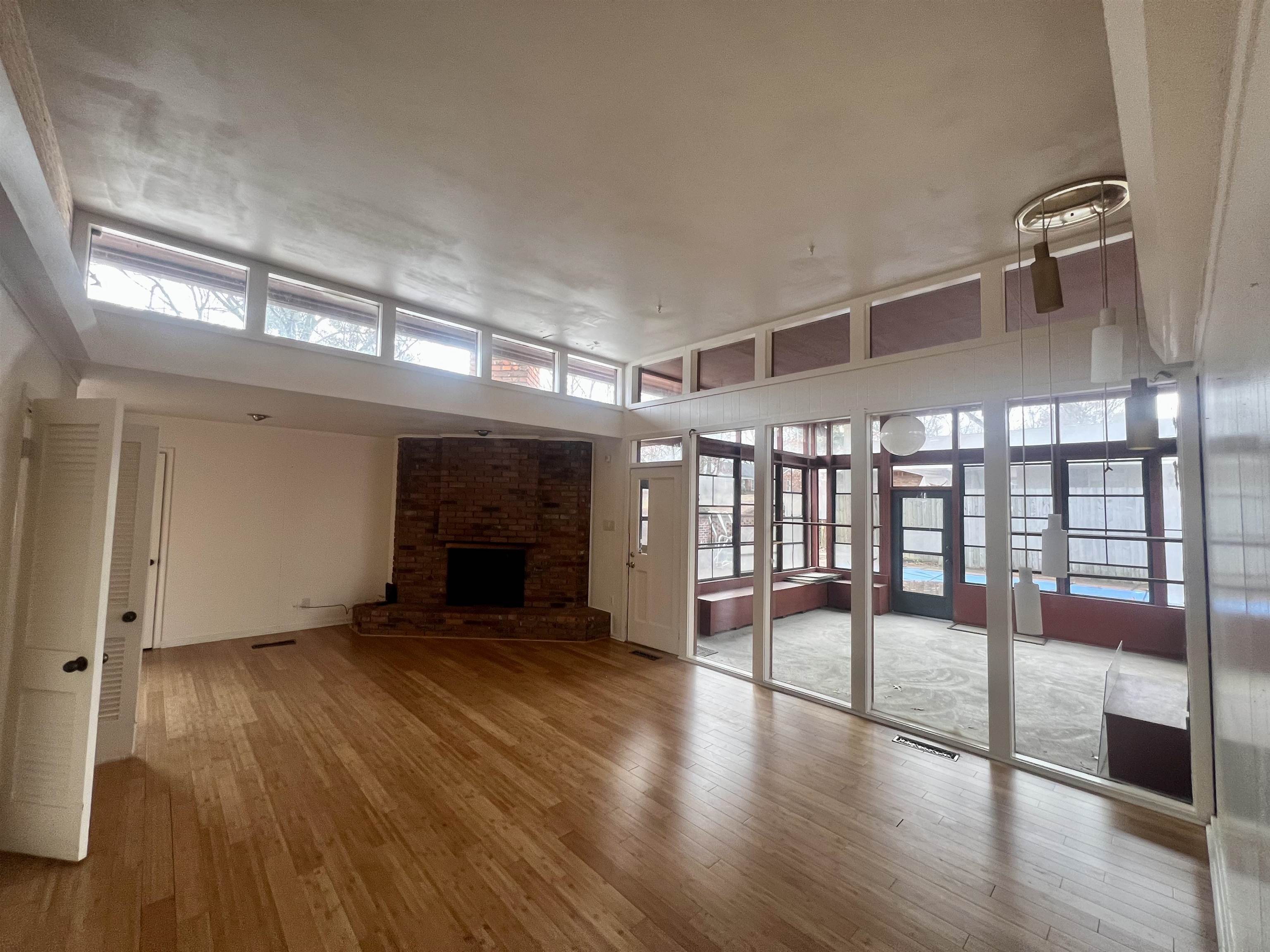 3153 Kirkcaldy Road Memphis, TN 38128 - Photo 23 of 28 Unfurnished living room with light wood finished floors and a brick fireplace