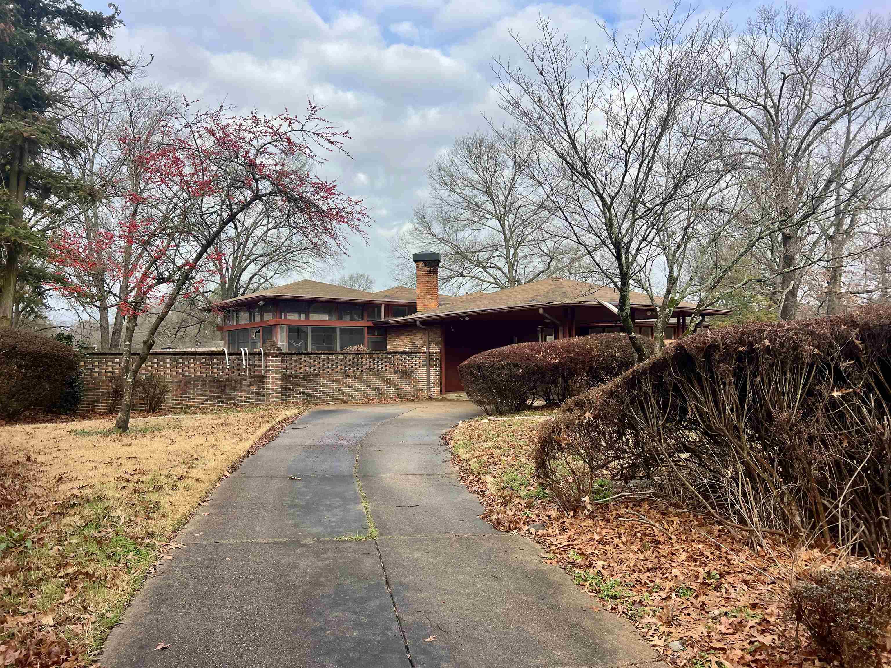 3153 Kirkcaldy Road Memphis, TN 38128 - Photo 3 of 28 View of home's exterior featuring asphalt driveway and a chimney