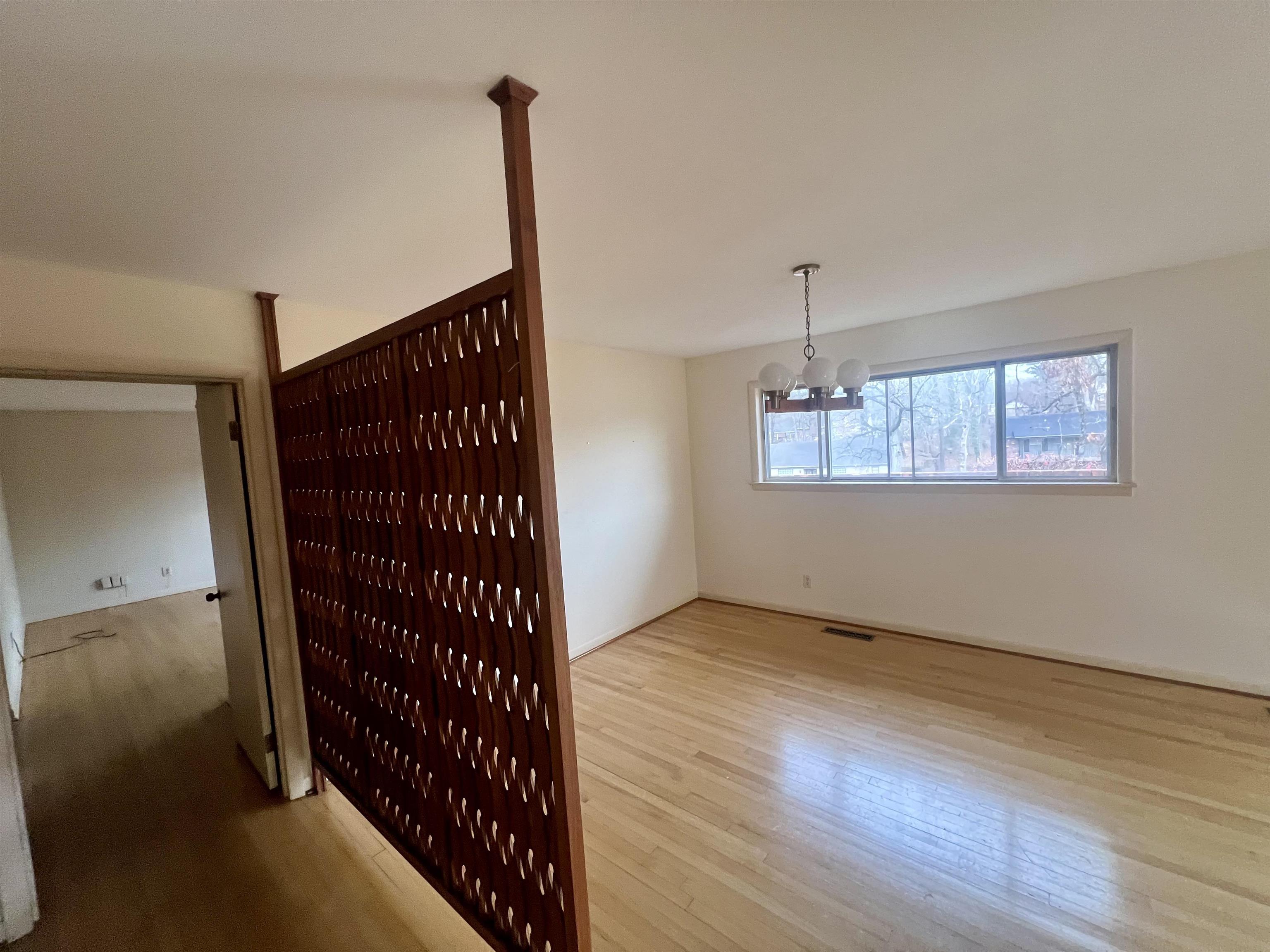 3153 Kirkcaldy Road Memphis, TN 38128 - Photo 7 of 28 Unfurnished living room featuring light wood finished floors and suspended lighting