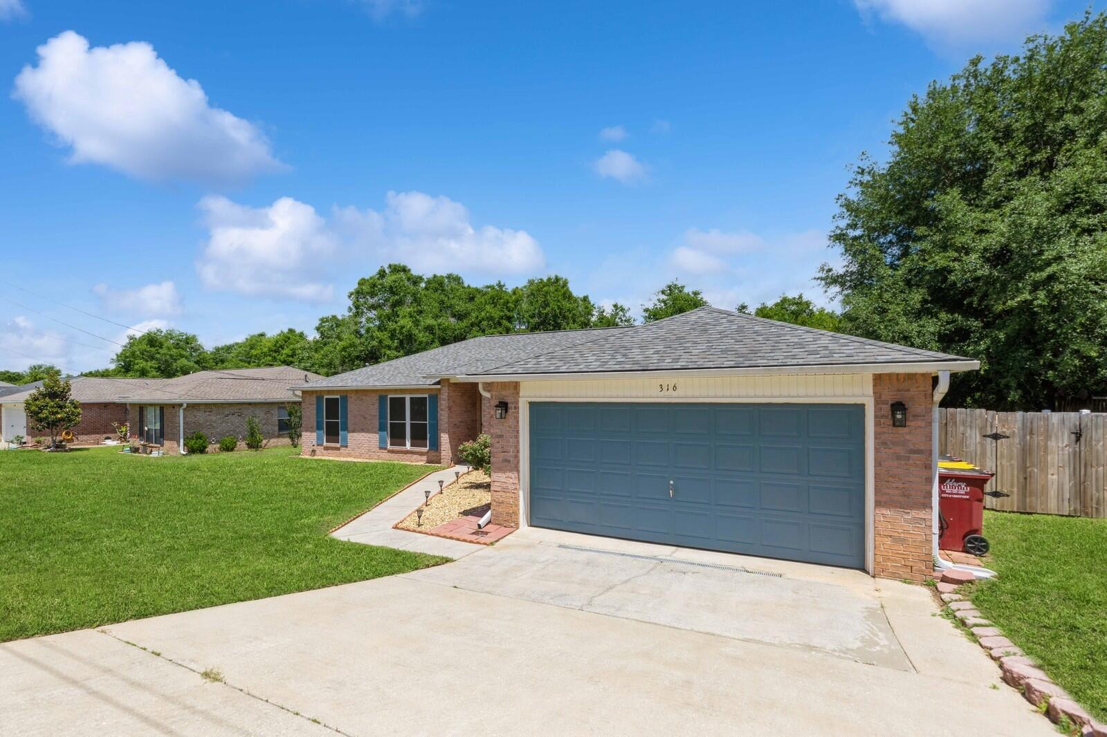 316 Egan Drive Crestview, FL 32536 - Photo 1 of 32 a view of a house with a backyard and a garage