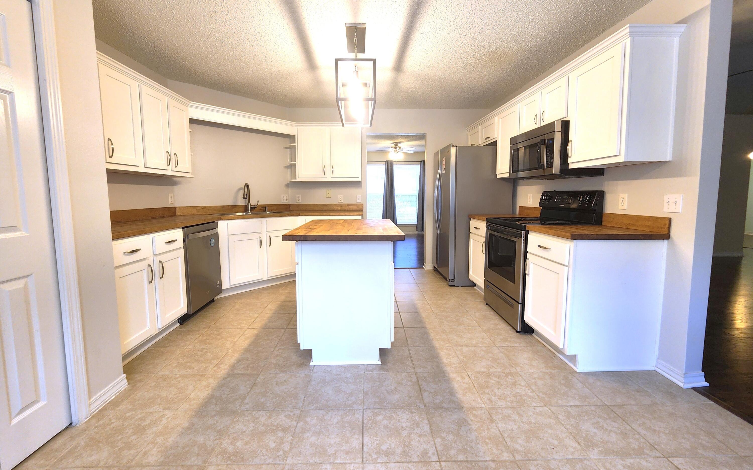316 Egan Drive Crestview, FL 32536 - Photo 12 of 32 a kitchen with stainless steel appliances granite countertop a stove top oven a sink a counter top space and cabinets