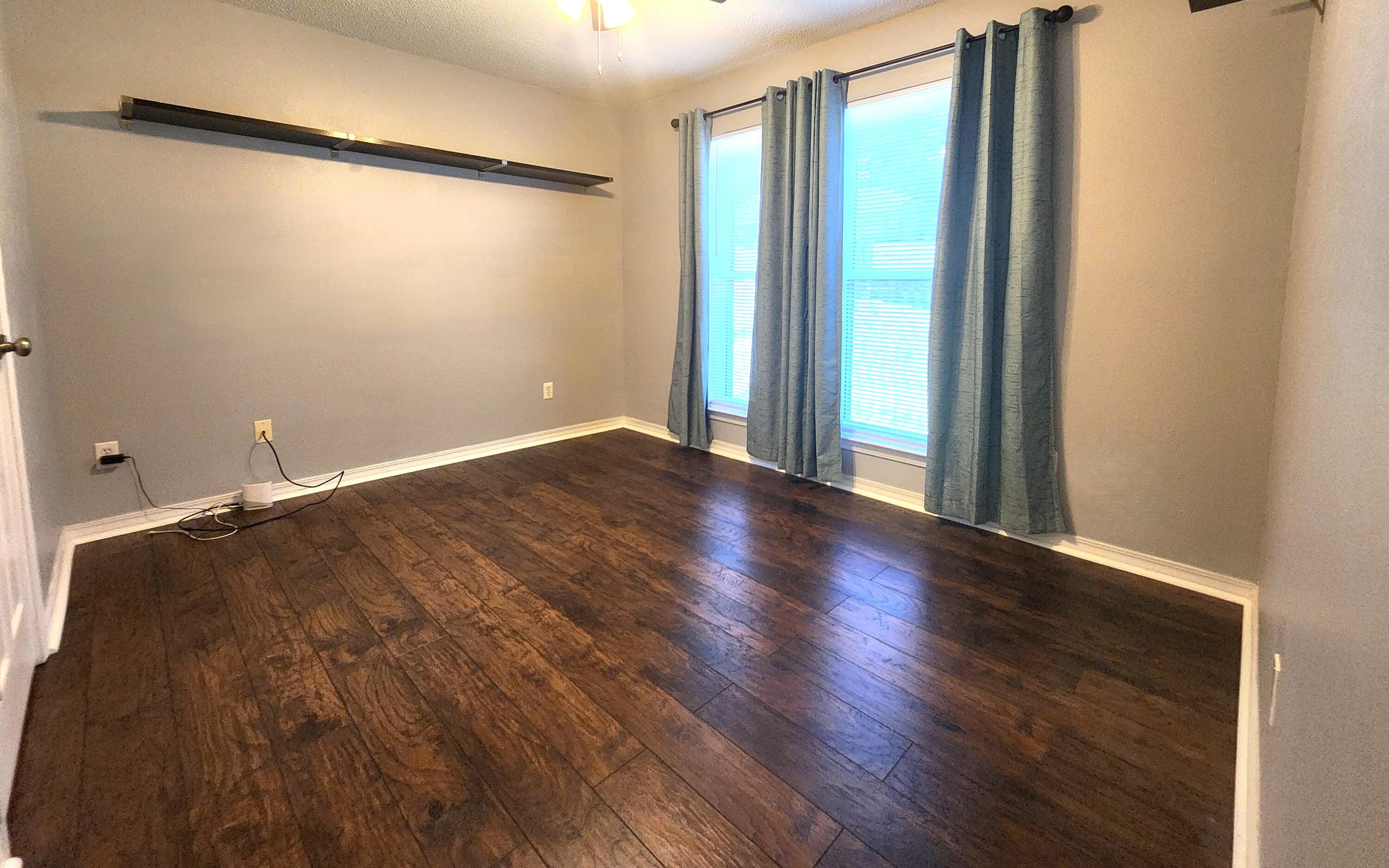 316 Egan Drive Crestview, FL 32536 - Photo 21 of 32 a view of a room with wooden floor and a window