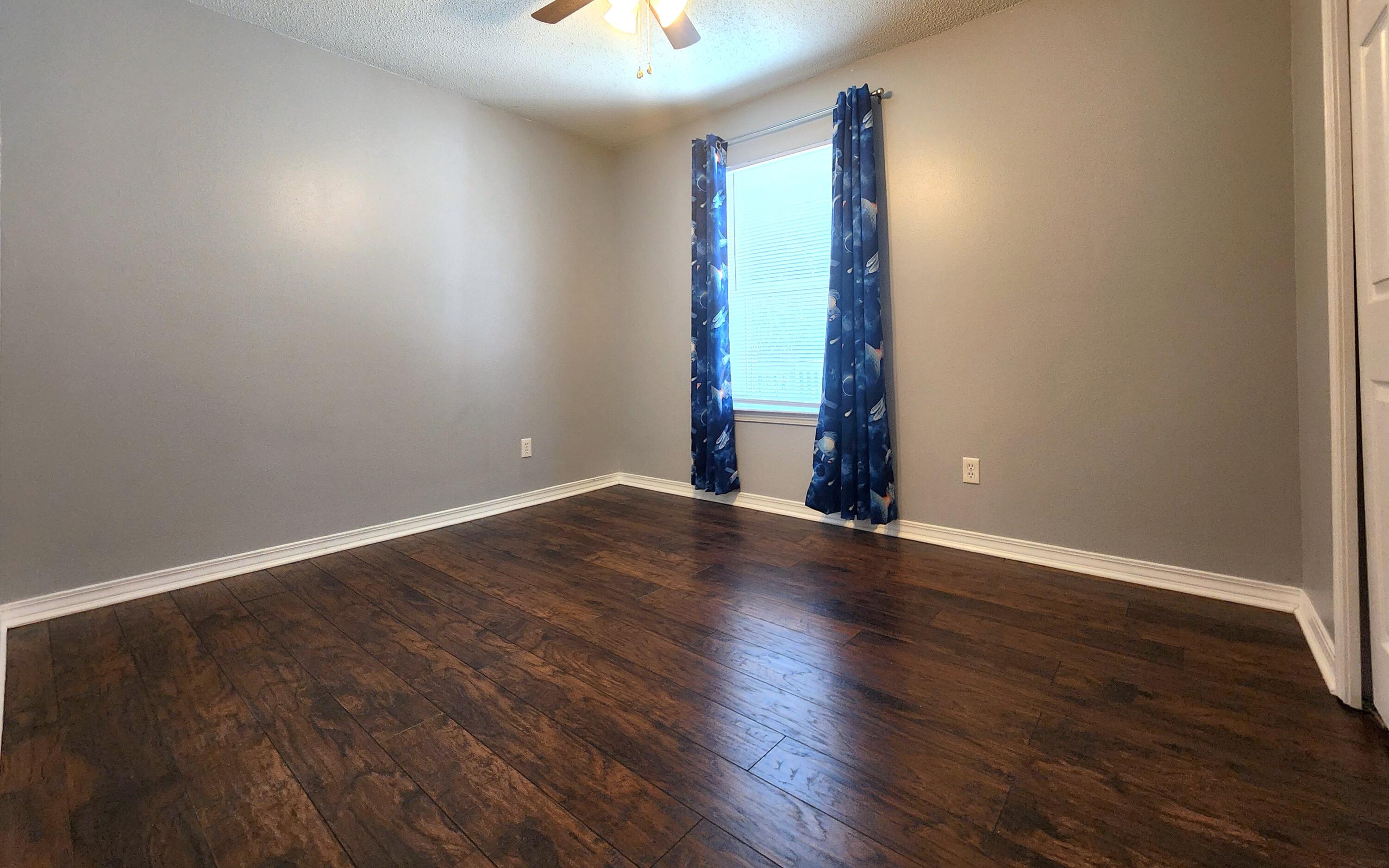 316 Egan Drive Crestview, FL 32536 - Photo 23 of 32 an empty room with wooden floor and closet