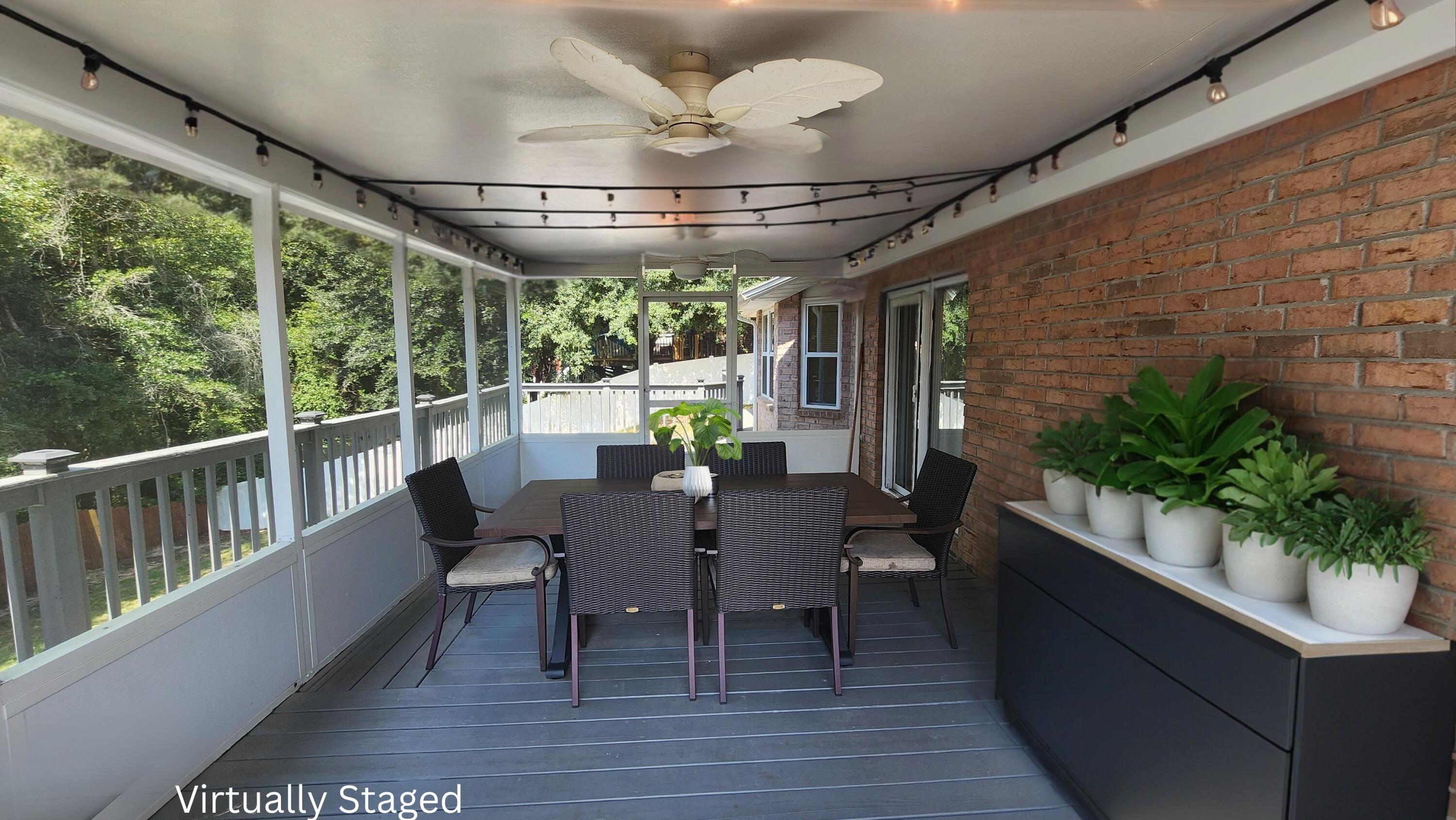 316 Egan Drive Crestview, FL 32536 - Photo 26 of 32 a view of a patio with a table chairs and a potted plant
