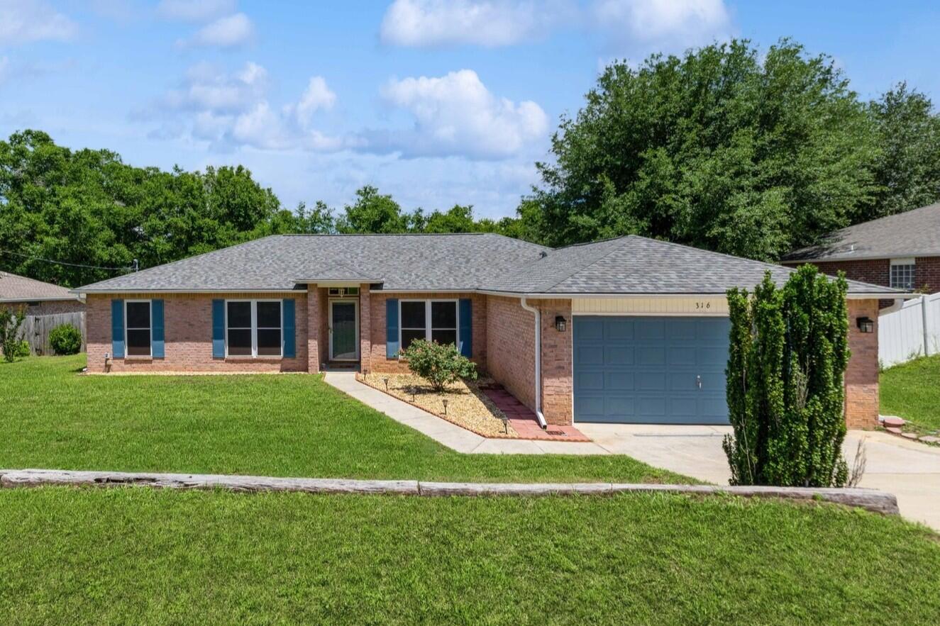 316 Egan Drive Crestview, FL 32536 - Photo 3 of 32 a front view of a house with a yard