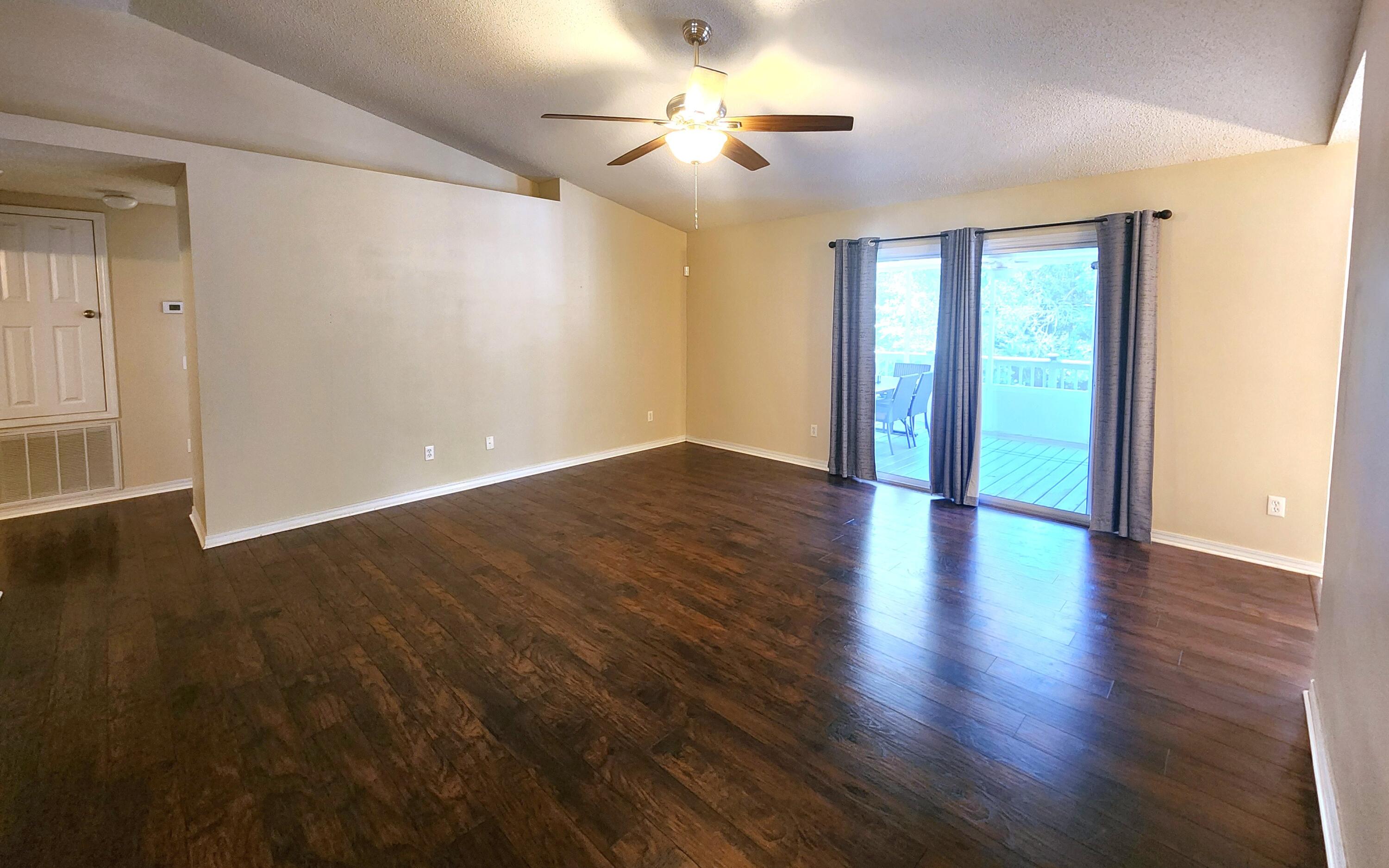 316 Egan Drive Crestview, FL 32536 - Photo 9 of 32 a view of an empty room with wooden floor and a window
