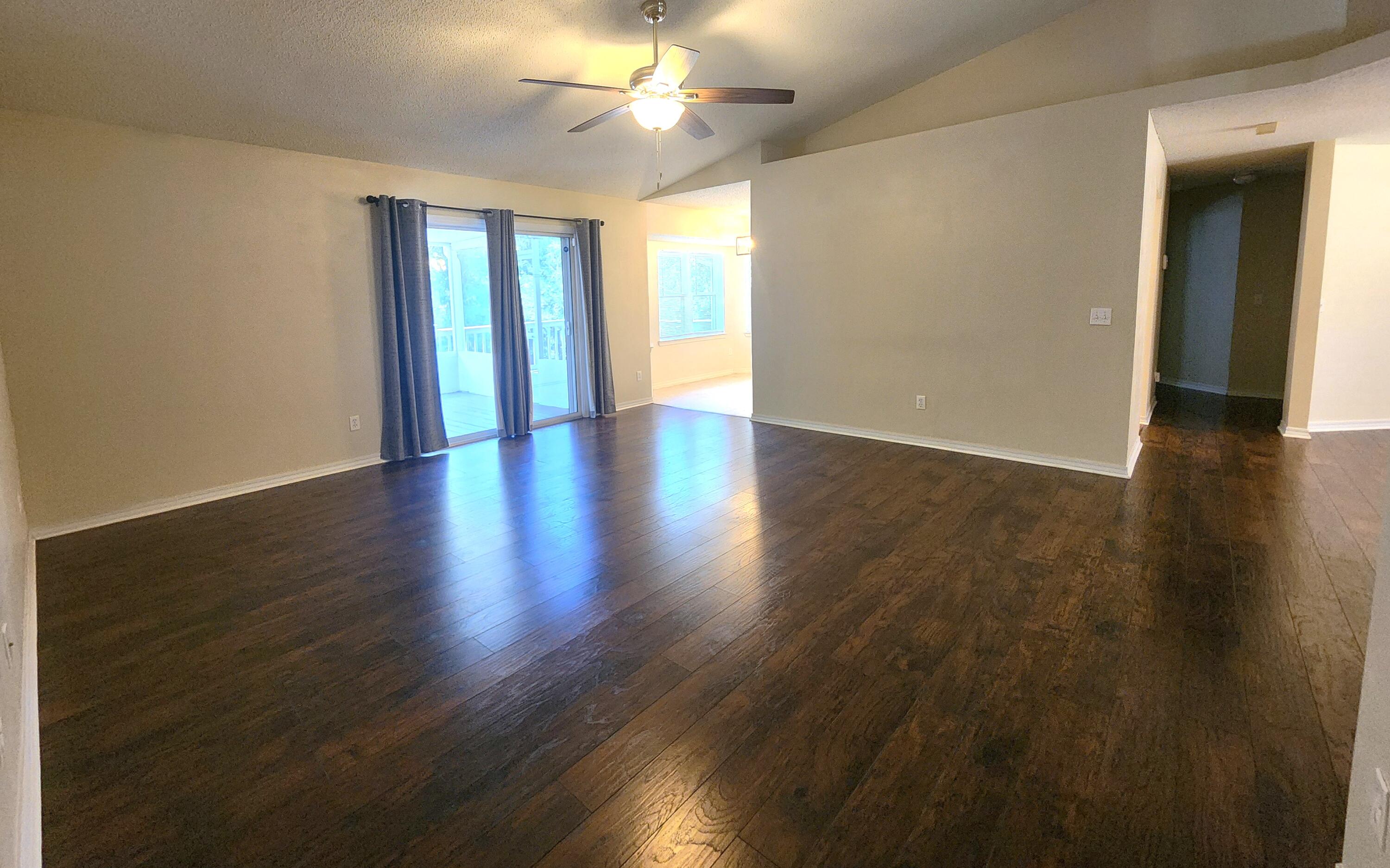 316 Egan Drive Crestview, FL 32536 - Photo 10 of 32 an empty room with wooden floor and windows