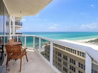 a balcony with table and chairs