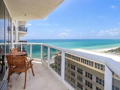 4775 Collins Avenue, Unit 2105 Miami Beach, FL 33140 - Photo 1 of 21 a balcony with table and chairs