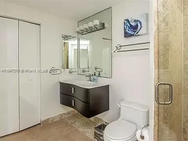 a bathroom with a sink vanity mirror and toilet