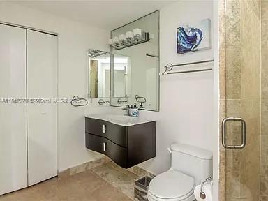 4775 Collins Avenue, Unit 2105 Miami Beach, FL 33140 - Photo 6 of 21 a bathroom with a sink vanity mirror and toilet