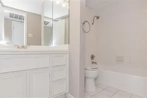 a bathroom with a shower a toilet and sink