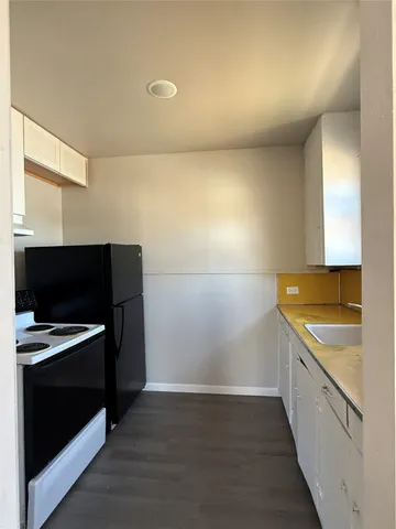 a kitchen with a sink and a stove top oven
