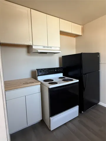 a stove top oven sitting inside of a kitchen