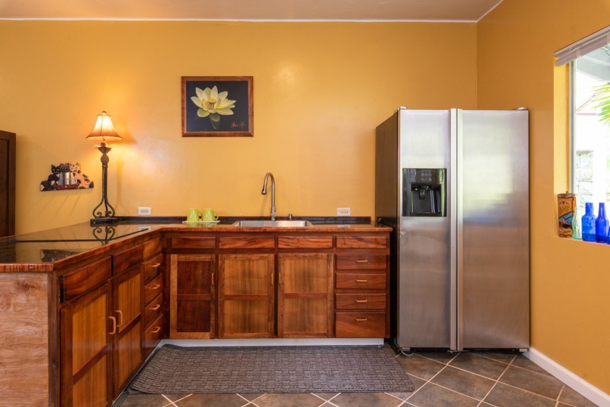 44-2325 Middle Road Honokaa, HI 96727 - Photo 18 of 28 a kitchen with stainless steel appliances granite countertop a refrigerator and a sink