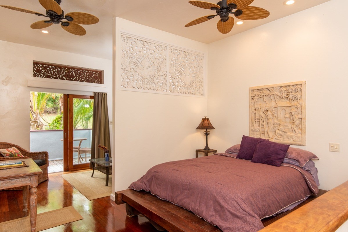 44-2325 Middle Road Honokaa, HI 96727 - Photo 19 of 28 a bedroom with a bed and a chandelier