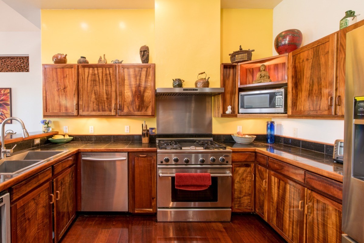 44-2325 Middle Road Honokaa, HI 96727 - Photo 7 of 28 a kitchen with stainless steel appliances granite countertop a stove a sink and a microwave