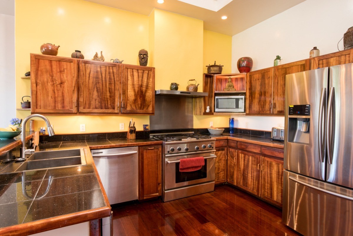 44-2325 Middle Road Honokaa, HI 96727 - Photo 8 of 28 a kitchen with stainless steel appliances granite countertop a stove top oven a sink and dishwasher