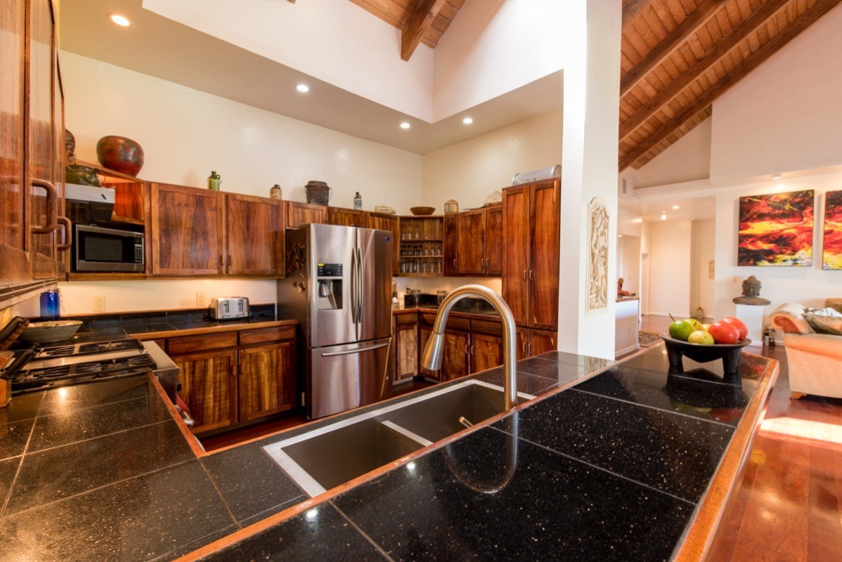 44-2325 Middle Road Honokaa, HI 96727 - Photo 9 of 28 a kitchen with stainless steel appliances granite countertop a stove refrigerator and cabinets