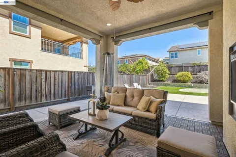 a balcony with furniture and a potted plant
