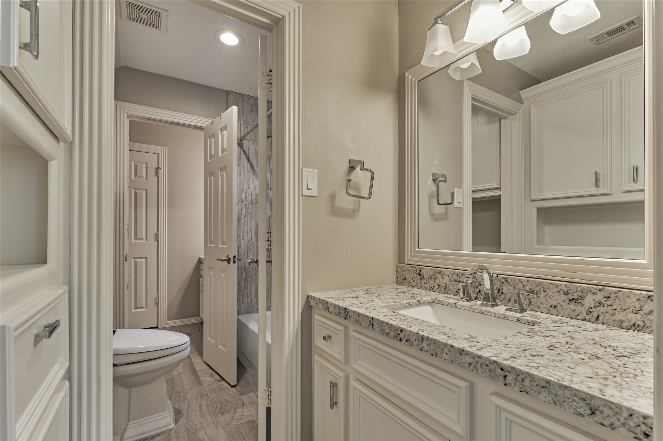 7 Gentry Oak Court Spring, TX 77381 - Photo 34 of 50 a bathroom with a granite countertop sink toilet and shower