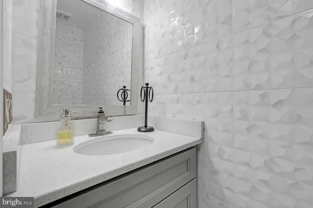 a kitchen with stainless steel appliances granite countertop a refrigerator a stove and a sink with wooden floor