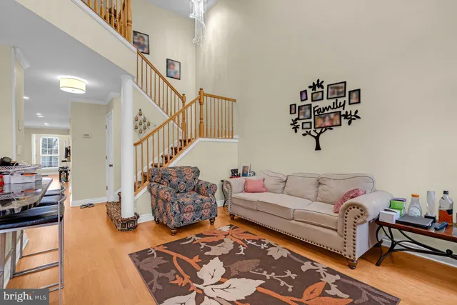 a kitchen with stainless steel appliances granite countertop a refrigerator a stove and a sink with wooden floor