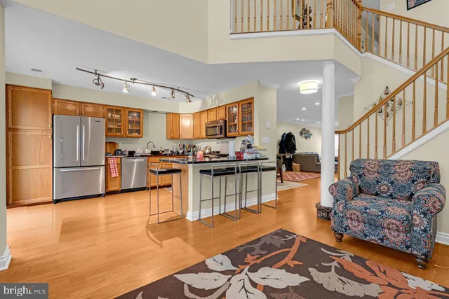 a kitchen with stainless steel appliances granite countertop a refrigerator and a stove top oven
