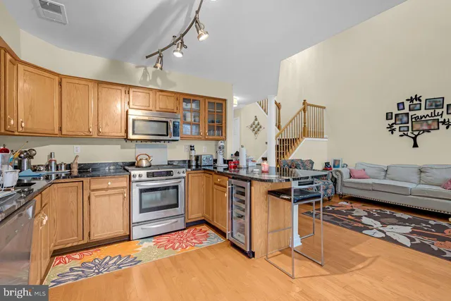 a kitchen with a sink cabinets and wooden floor