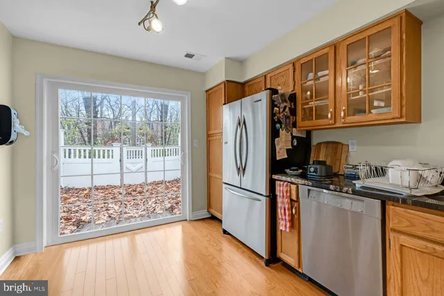 a kitchen with kitchen island stainless steel appliances a sink and cabinets