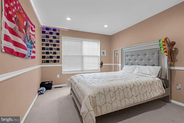 a bedroom with a bed and a book shelf