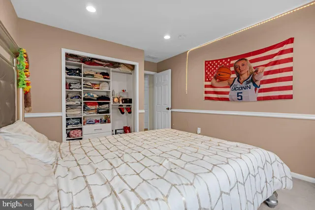 a bed sitting in a bedroom next to a window