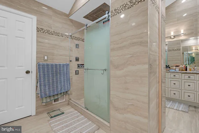 a bathroom with a double vanity sink toilet mirror and shower