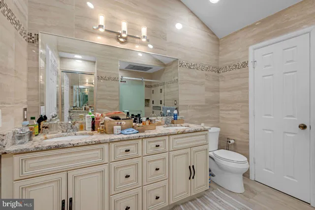a view of a hallway to a livingroom with wooden floor and a fireplace