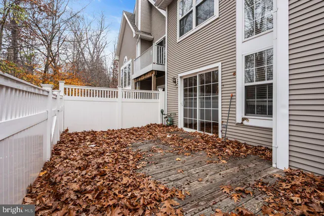 a view of a white house with a bench