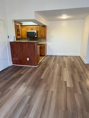 a view of kitchen with wooden floor