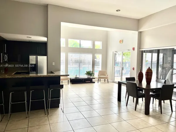 a view of a large dining room with furniture and floor to ceiling window