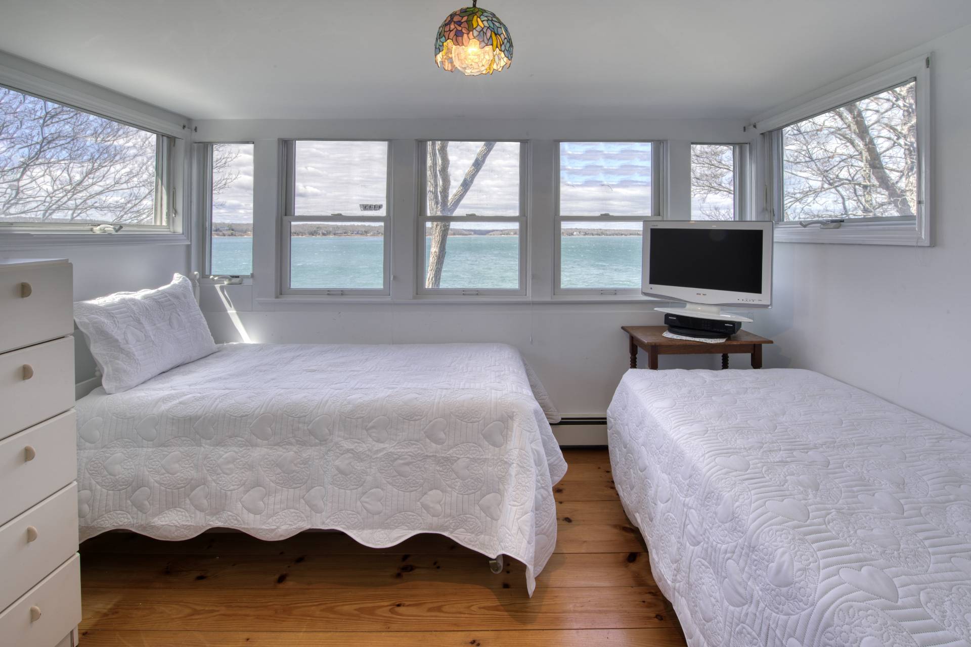201 Three Mile Harbor Road East Hampton, NY 11937 - Photo 14 of 19 a bedroom with a bed and wooden floor