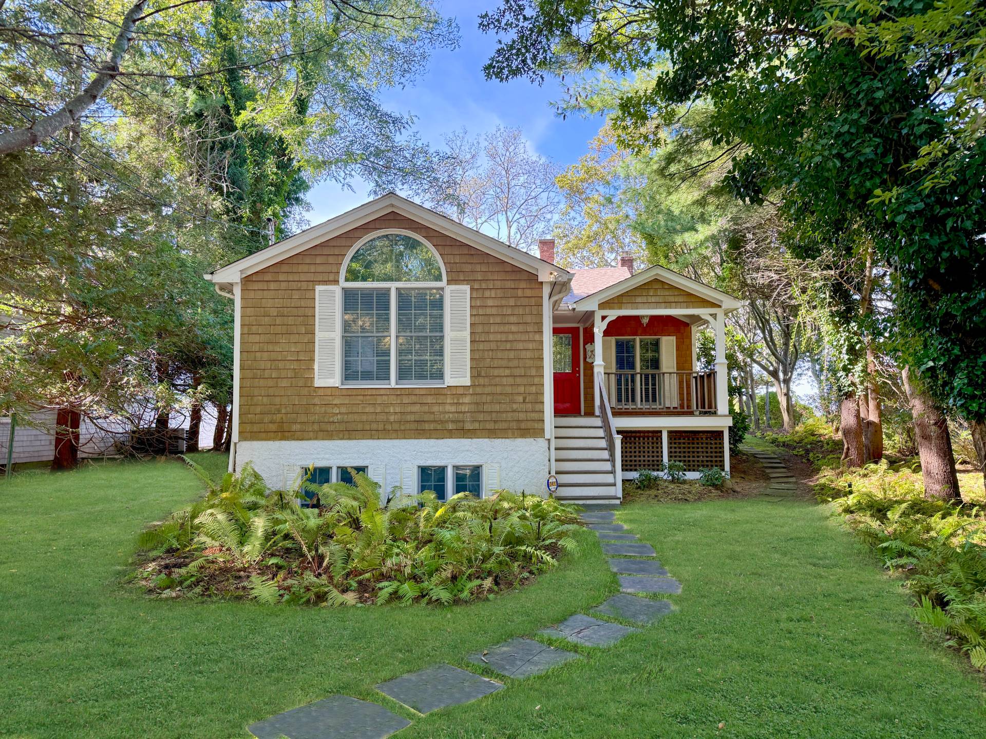 201 Three Mile Harbor Road East Hampton, NY 11937 - Photo 2 of 19 a front view of a house with a garden